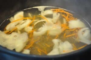 tteokguk rice cake soup boiling in pot