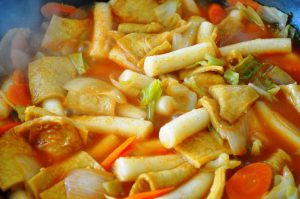 Tteokbokki - Korean spicy rice cake with vegetables, cooking in pan