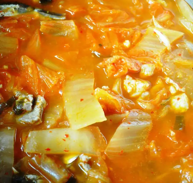 Kimchi Jjigae ready to cook in pot with everything added