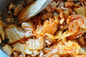 sauteeing kimchi and pork