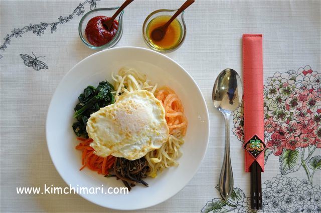 Table setting of Bibimbap served with gochujang and sesame oil