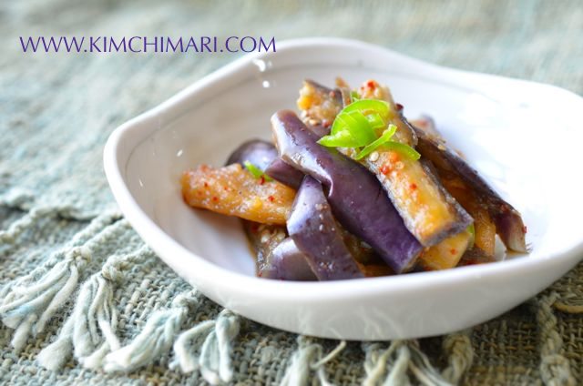 Steamed purple eggplant side dish in white bowl - side view