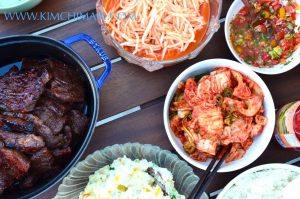 Korean BBQ party table with Kalbi, Radish Salad, Kimchi and Potato Salad