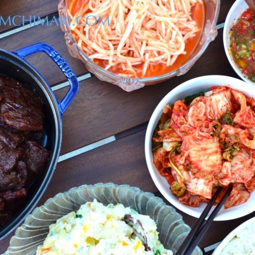 Korean BBQ party table with Kalbi, Radish Salad, Kimchi and Potato Salad