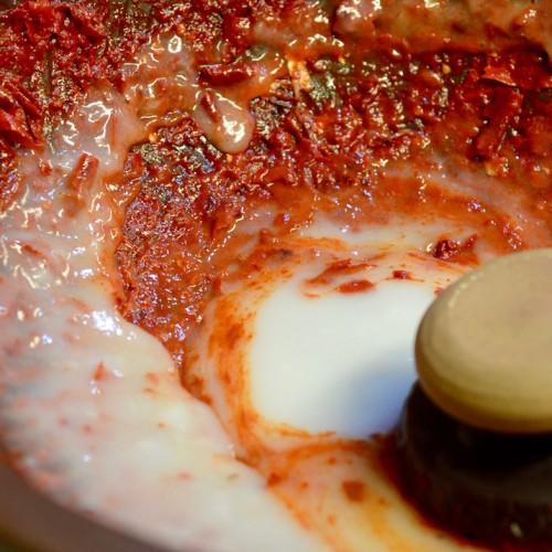 Mixing sweet rice paste with red chili pepper for Kimchi