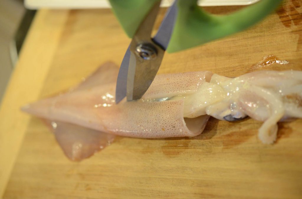 cutting squid open with scissors