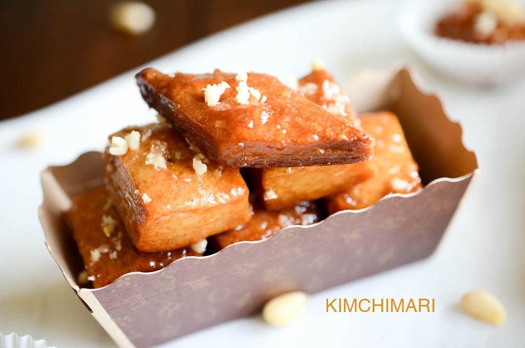 Korean yakgwa cookies sitting in. a small rectangular box. 