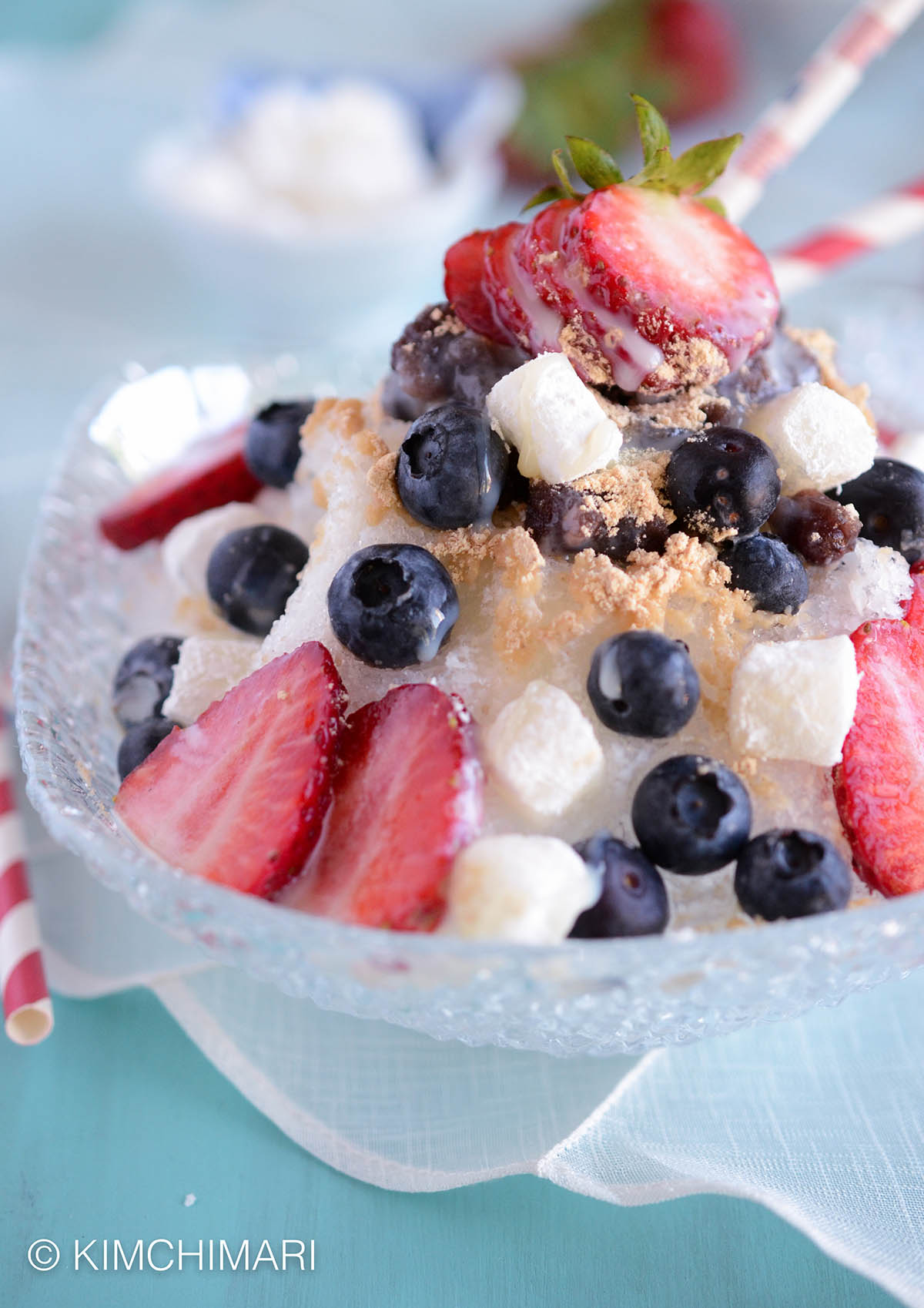 A photo of bingsu, a Korean dessert, topped with strawberries and blueberries. 