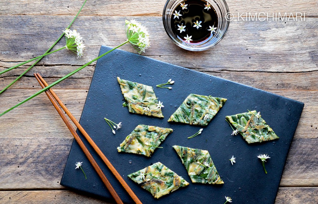 Buchujeon or Korean Chive Pancakes cut into diamond shapes with Chive flowers