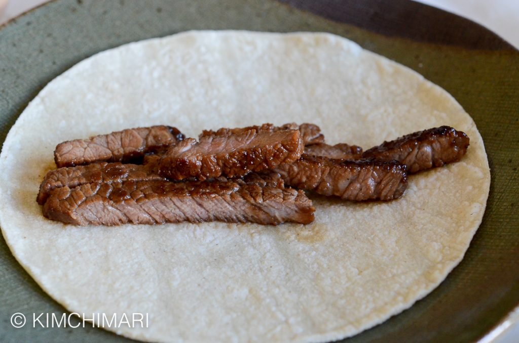 Kalbi meat strips on taco shell