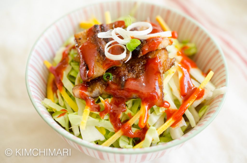 Miso Pork Belly rice bowl with cabbage, carrots, green onions and gochujang sauce