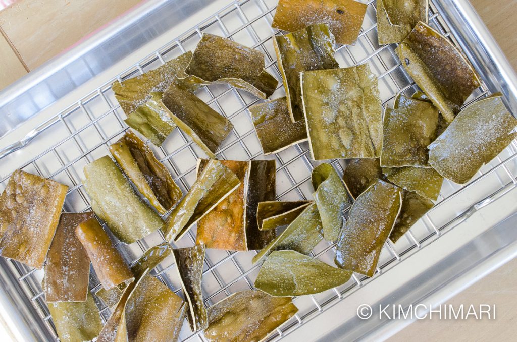 top view of Fried Kelp chips sprinkled with sugar on stainless cookie pan