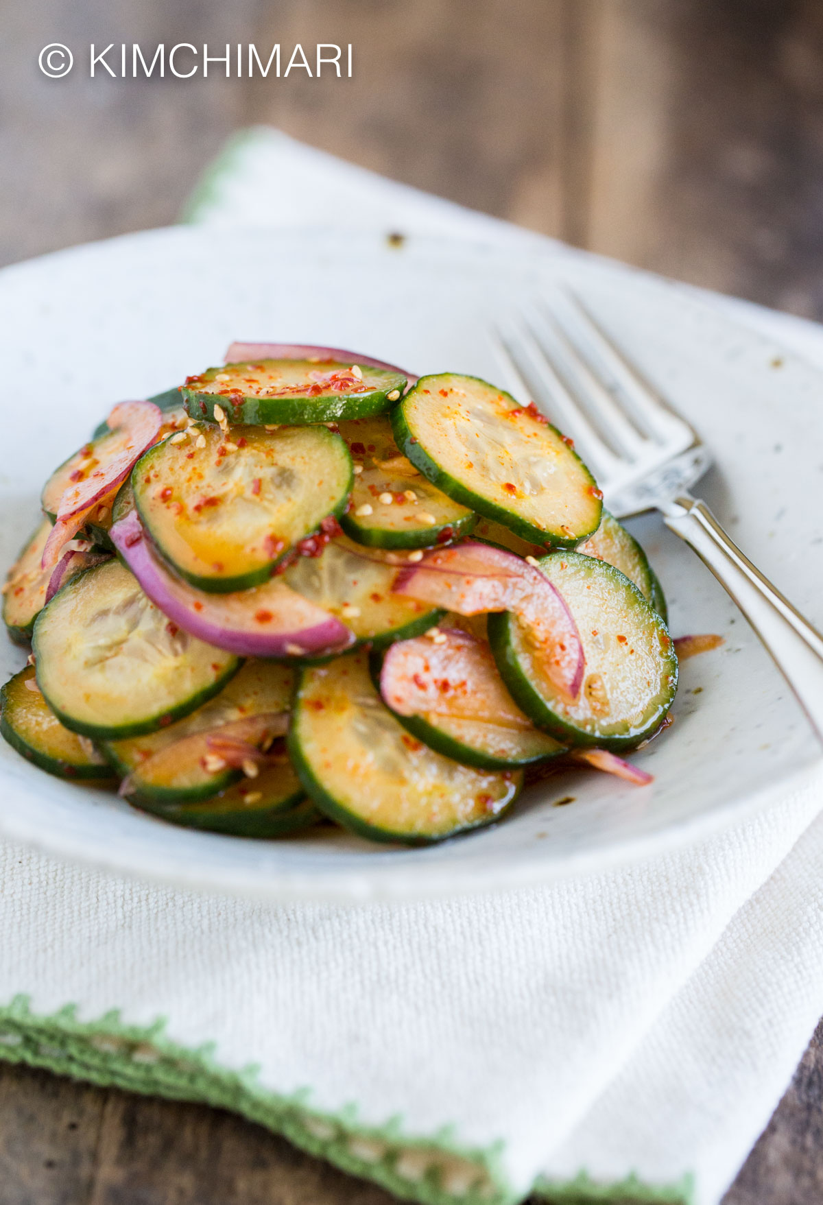 Asian Cucumber Salad Without Soy Sauce in white bowl with fork