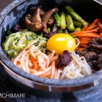 Bibimbap in Stone Pot with vegetable and meat toppings and egg yolk