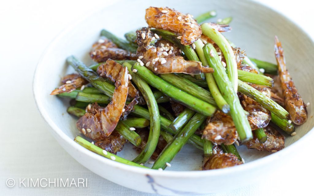 green garlic Scapes and Dried shrimp seafood banchan plated on white background