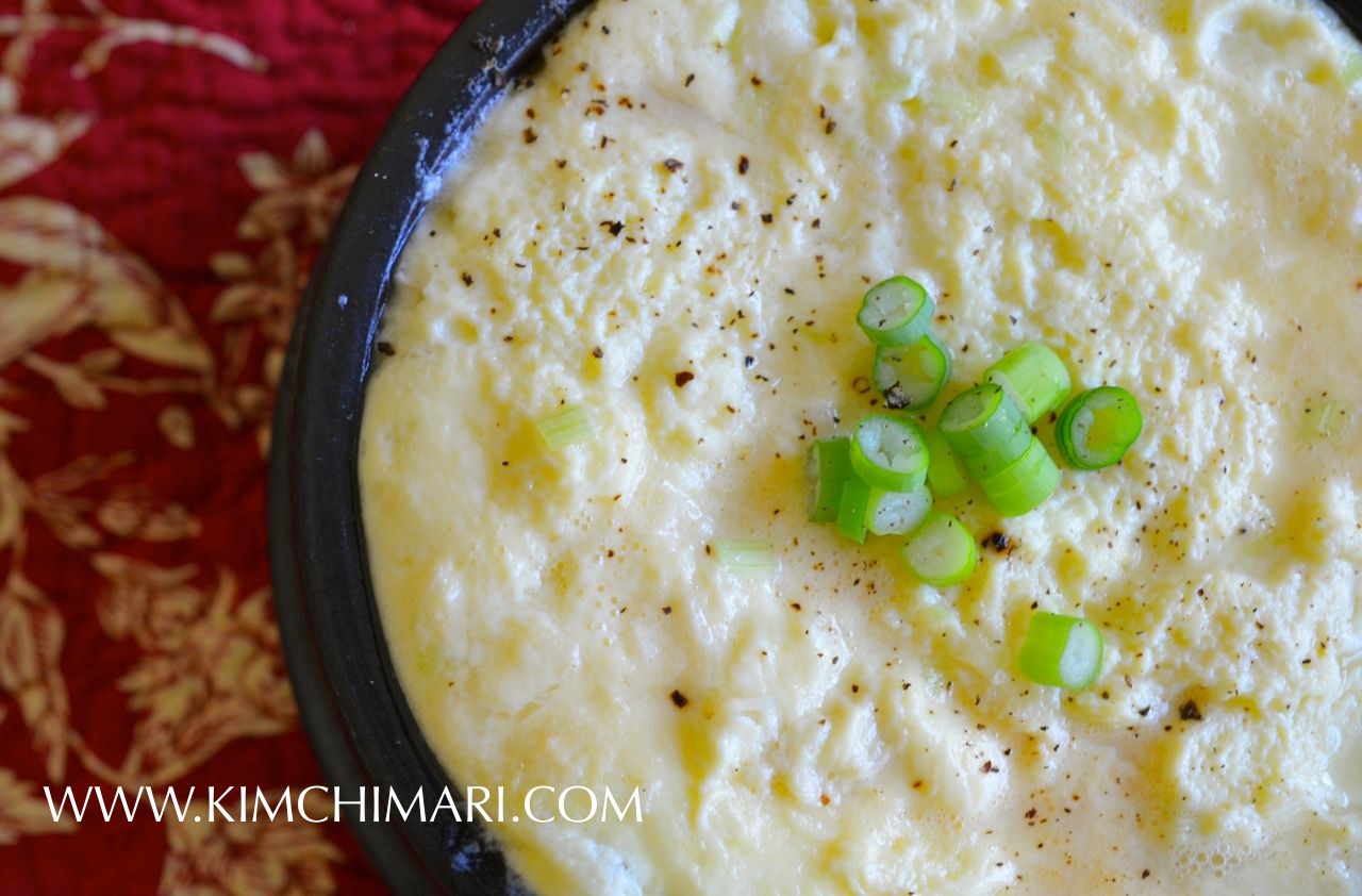 top view of Steamed Egg in Hot stone pot garnished with green onions