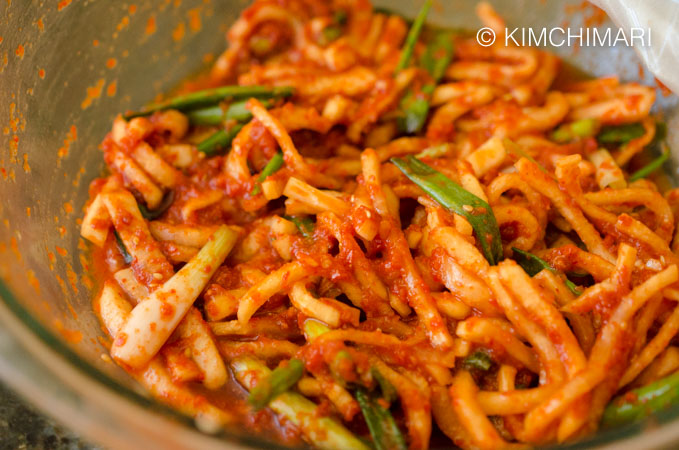 spicy radish kimchi salad all mixed with seasoning in bowl