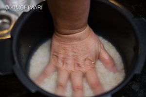 Measuring Rice Water with Hand