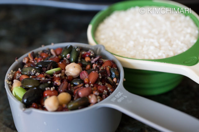 Defrosted frozen beans and white rice in measuring cups