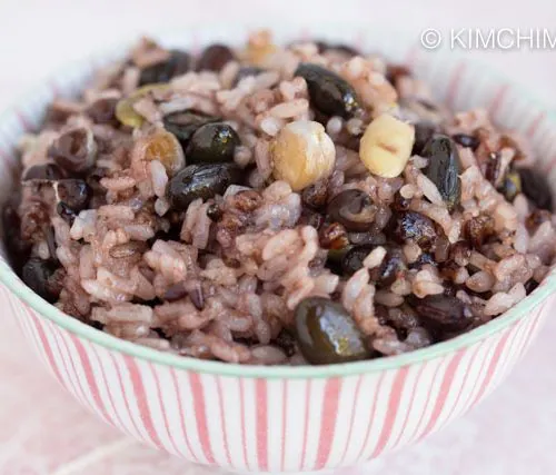 Closeup of multigrain rice cooked in pink striped bowl