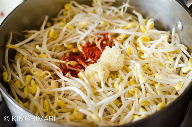 soybean sprouts in pot with garlic and chili powder added