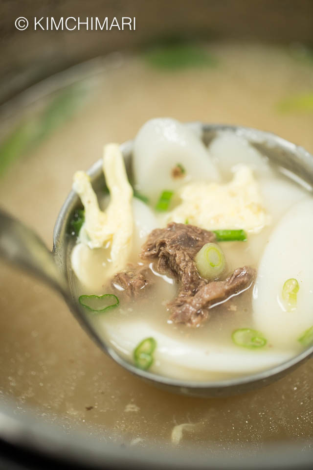 A ladle of finished tteokguk inside Instant Pot