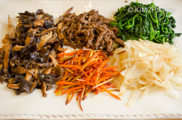 A plate of Japchae sauteed ingredients ready to be mixed