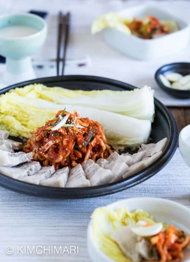 plate of pork belly cooked with Doenjang with cabbage and radish salad