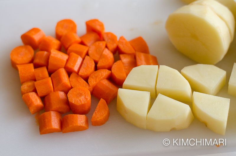 cut potatoes and carrots on cutting board