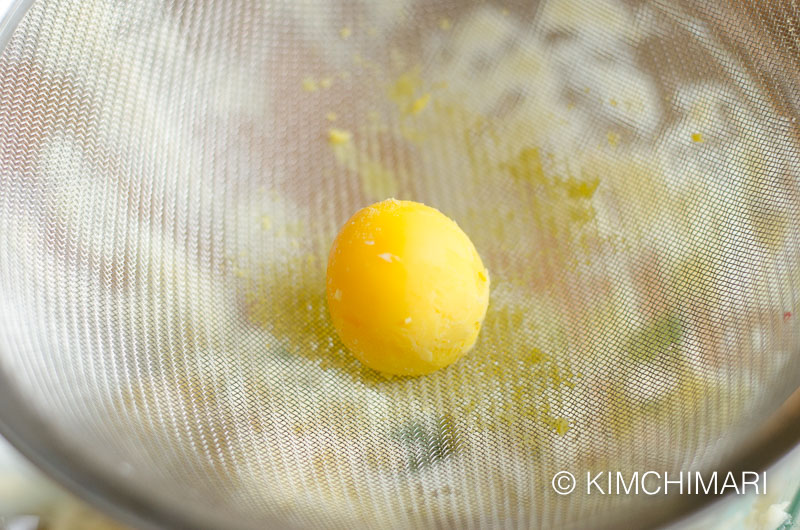 cooked egg yolk on sieve for grating the yolk as garnish