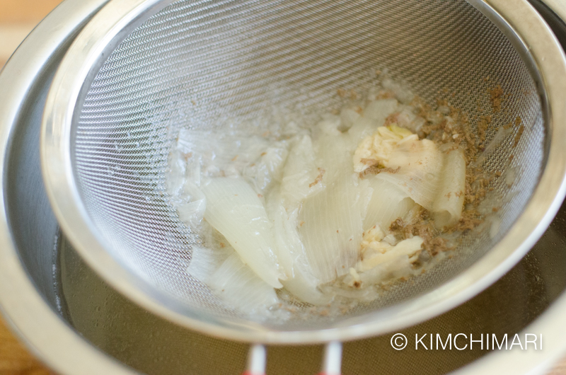 bits of beef, onions and garlic left in the fine sieve after straining