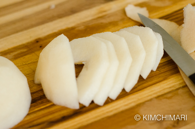 slices of peeled asian on cutting board