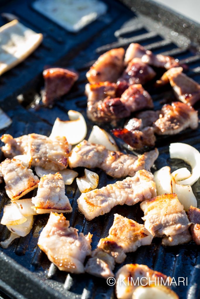 Samgyeopsal and onions grilling on Korean Grill Pan