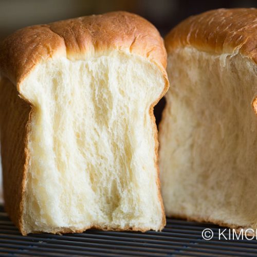 milk bread loaf split into two with side showing
