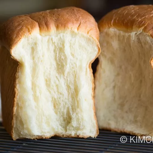 milk bread loaf split into two with side showing