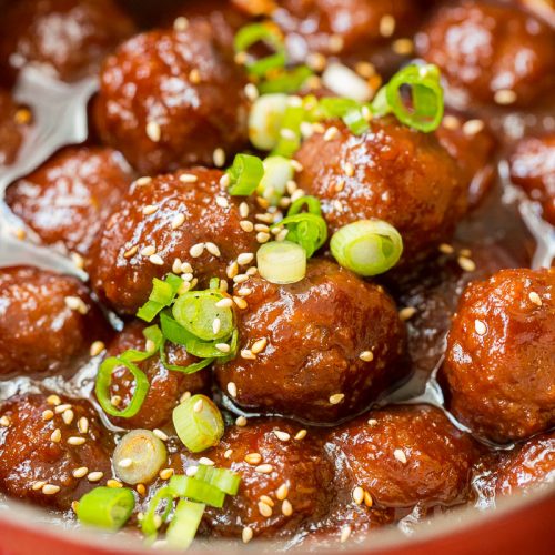 gochujang meatballs finished in pot topped with green onions and sesame