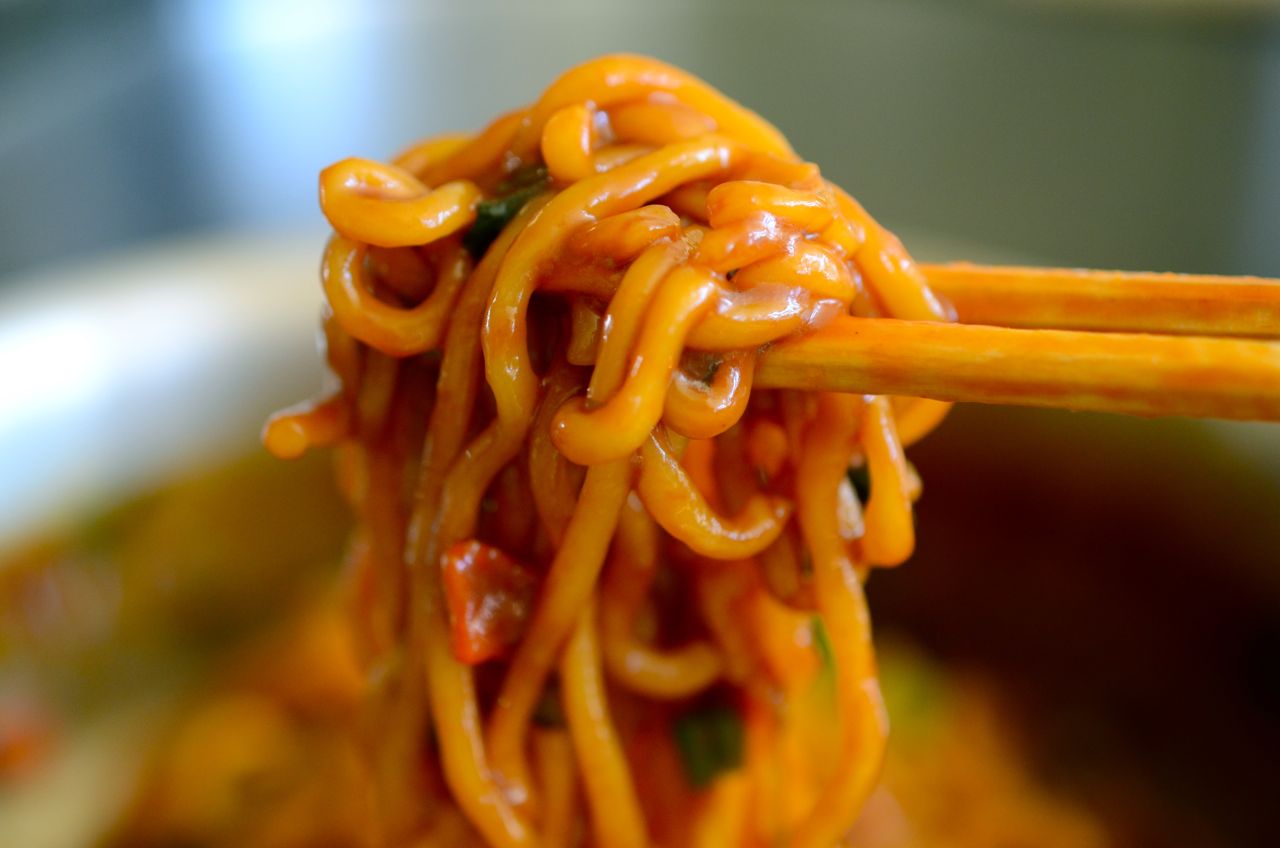 jjapaguri noodles lifted with chopsticks