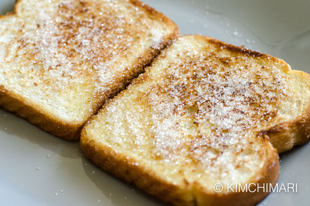 sugar sprinkled on butter browned toasts on plate