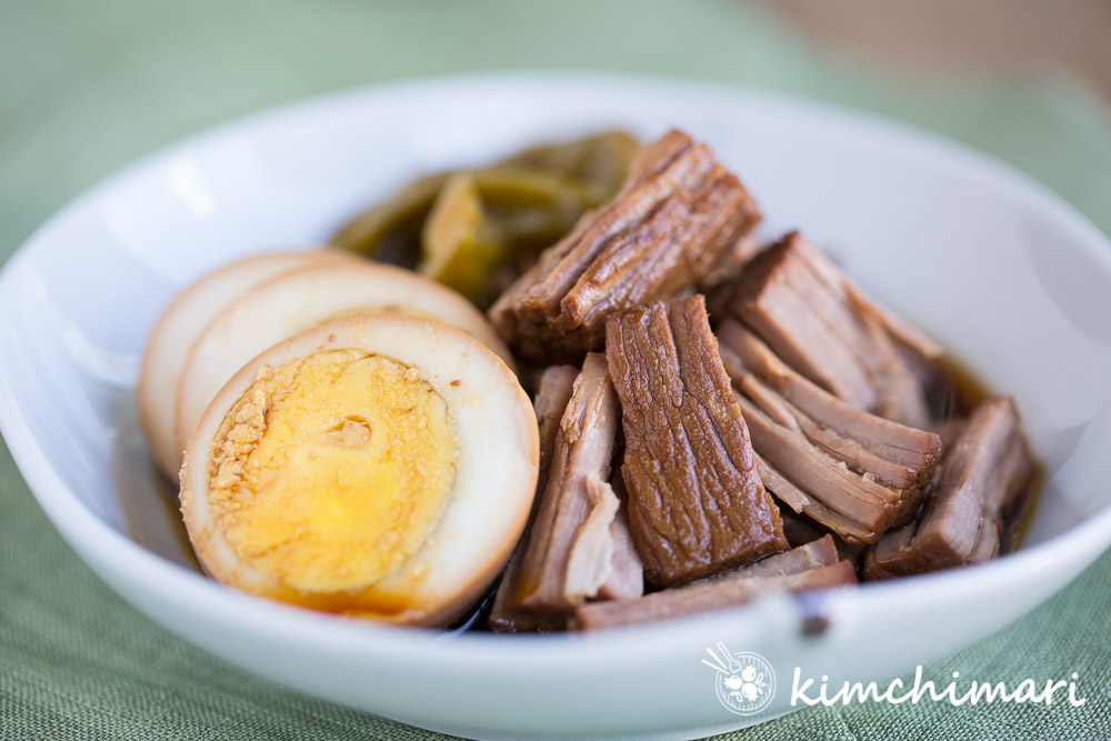 Instant Pot Jangjorim plated with slices of egg, peppers and shredded meat