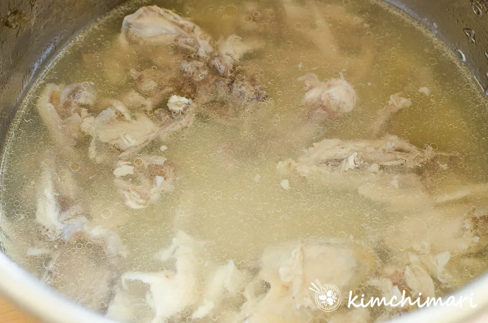 chicken bones in pot with broth for dakjuk
