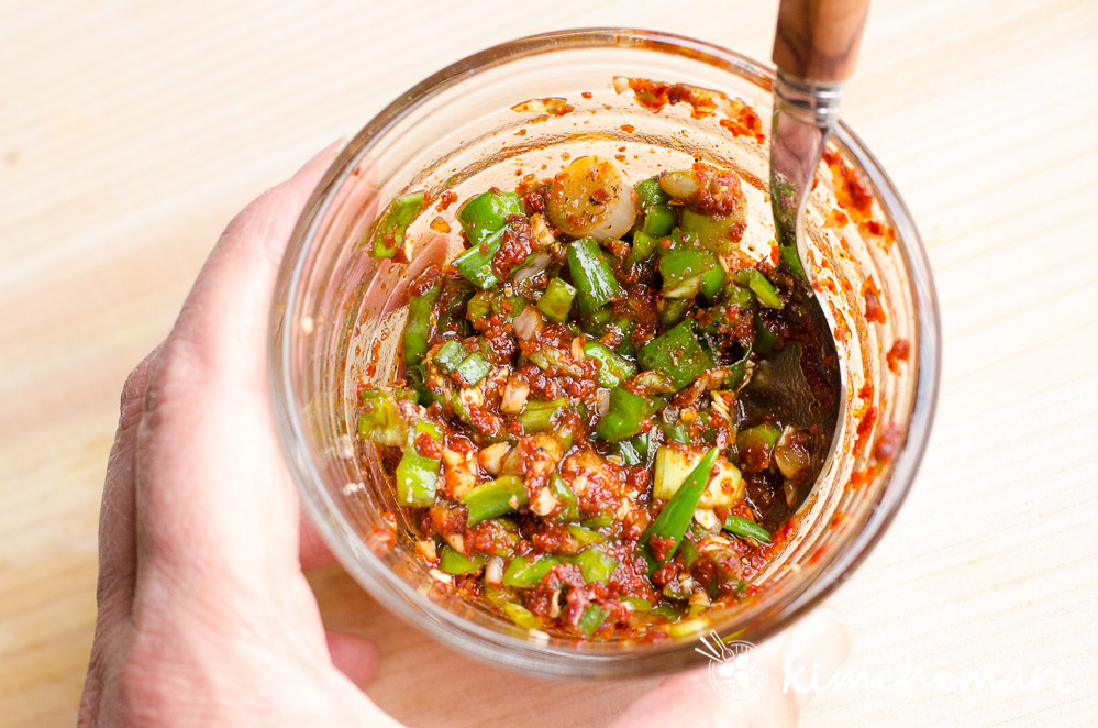 mixed sauce in glass bowl with a spoon inside