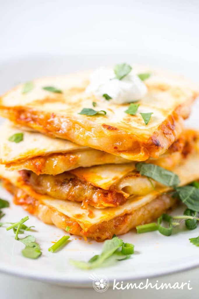 Kimchi Quesadilla sliced and stacked on white plate