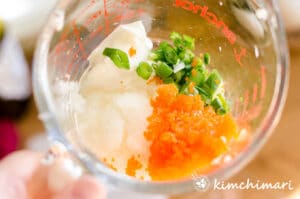 mayo masago onions are in a glass pyrex mixing cup