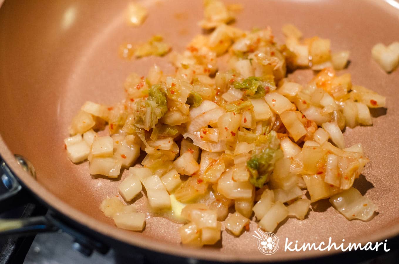 chopped kimchi and butter in pan ready to saute