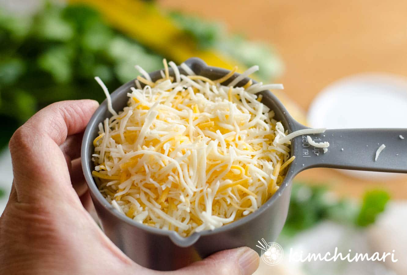 shredded cheese in measuring cup