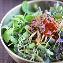 sprouts or microgreens bibimbap served in traditional korean brass bowl
