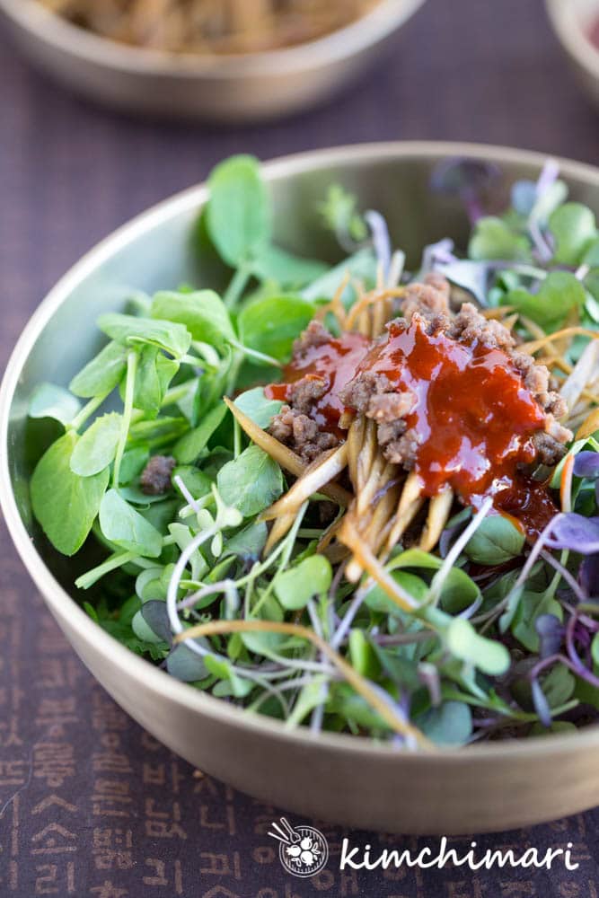 sprouts or microgreens bibimbap served in traditional korean brass bowl