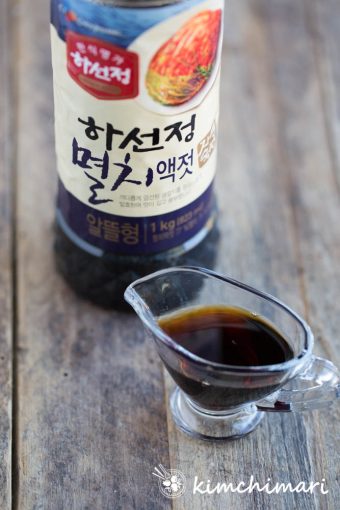 korean anchovy fish sauce in small glass gravy boat with bottle of CJ fish sauce