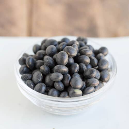 black soybeans piled on small glass bowl