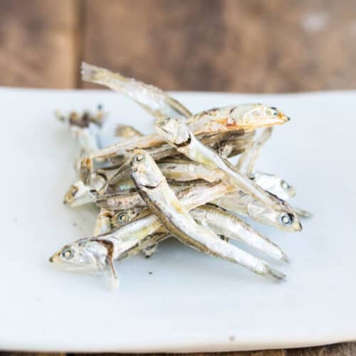 pile of dried soup anchovies on white plate